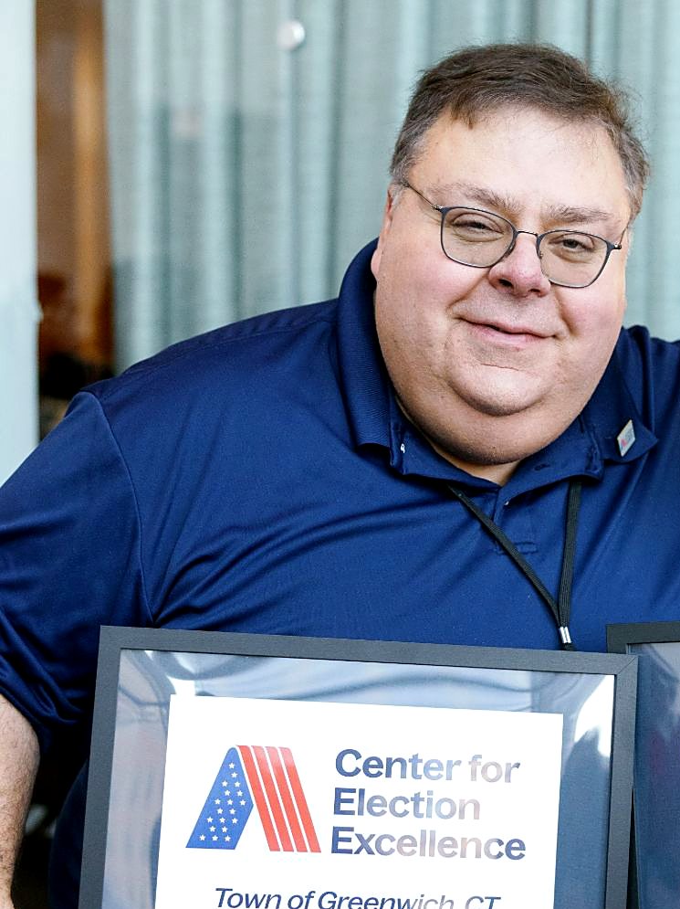 Fred DeCaro holding the Town of Greenwich Center for Election Excellence plaque